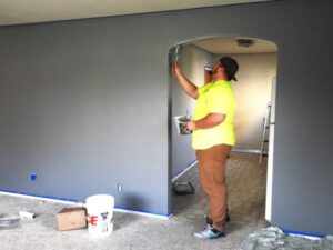 Man painting inside a house